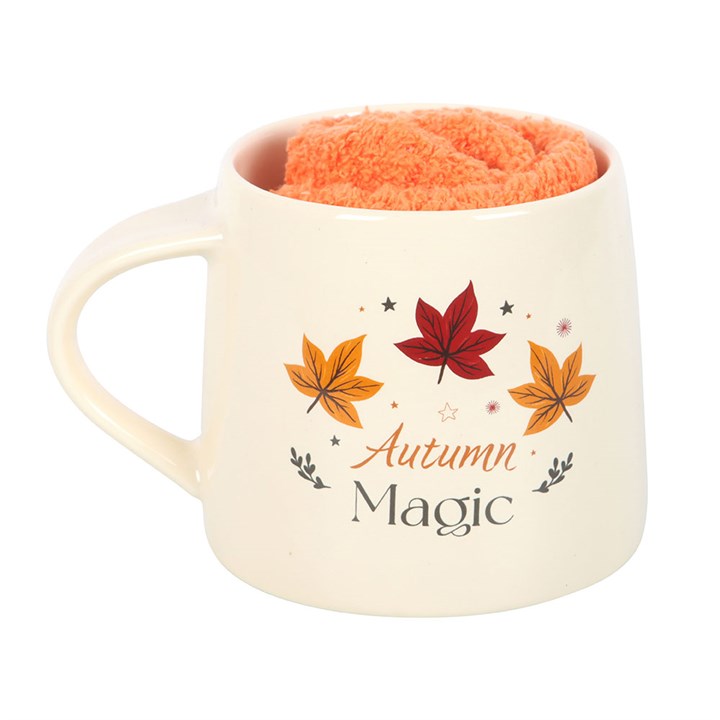 Mug with 'Autumn Magic' text and leaf designs on a white background