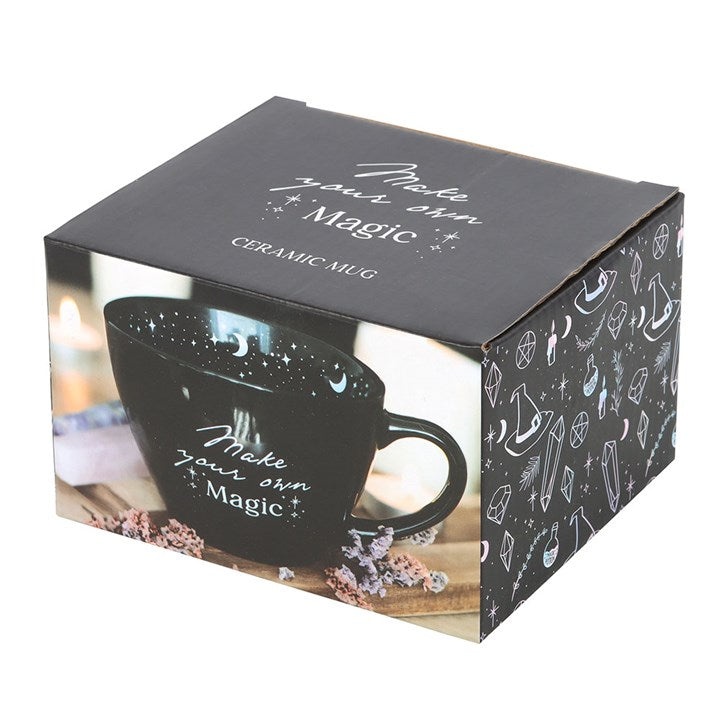 Black ceramic mug with 'Make your own Magic' text in a decorative box.
