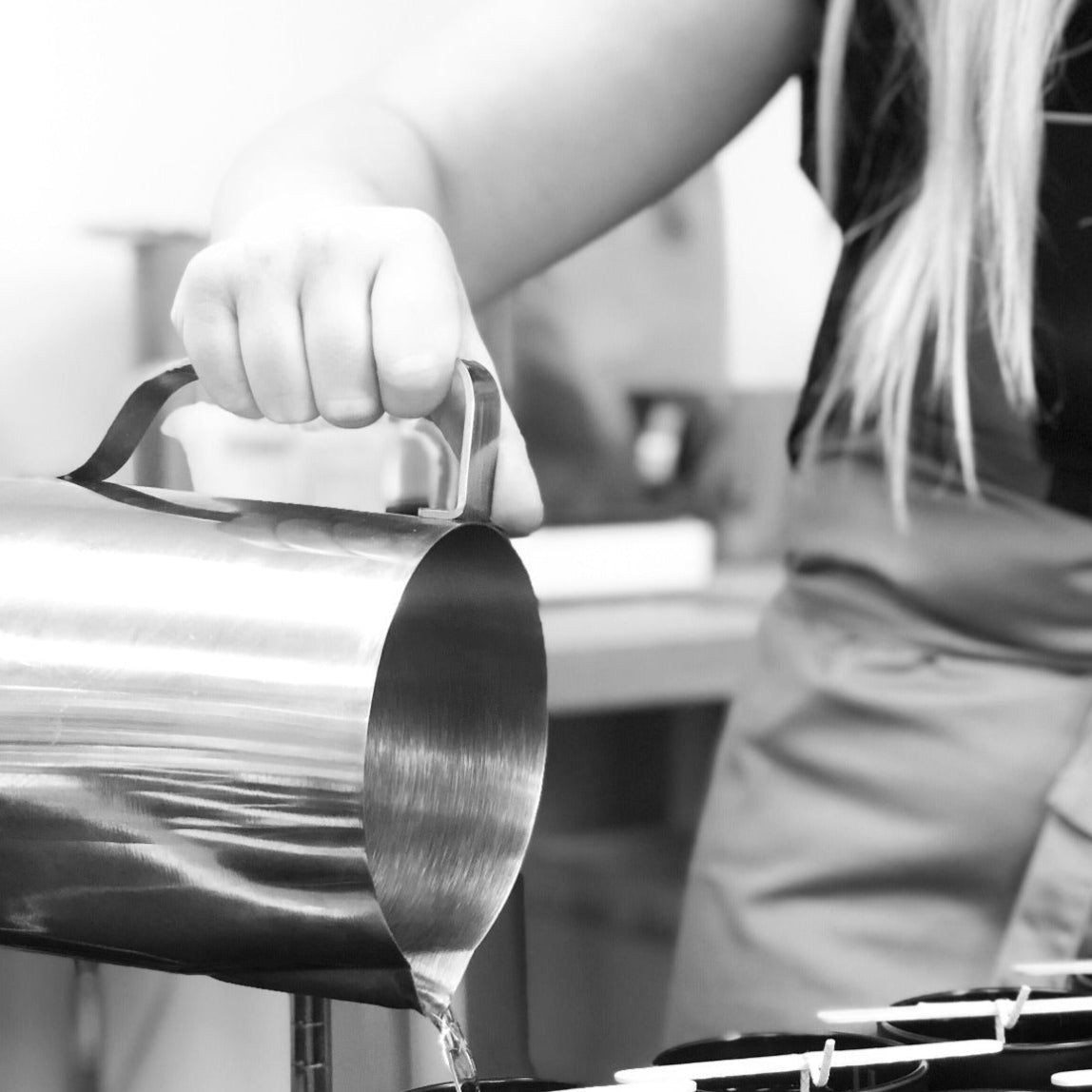 Hand pouring our rose fragranced candles for the panache rose candle tins gift