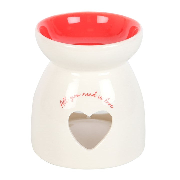 White ceramic oil burner with red interior and 'All you need is love' text on a white background