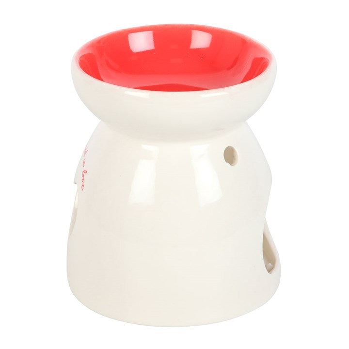 White ceramic oil burner with a red interior on a white background