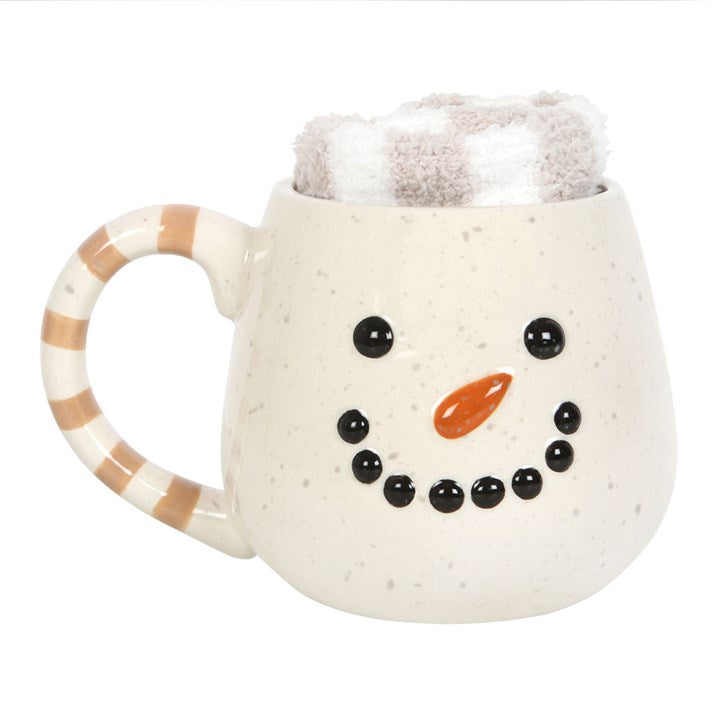 Snowman-themed ceramic mug with a striped handle on a white background