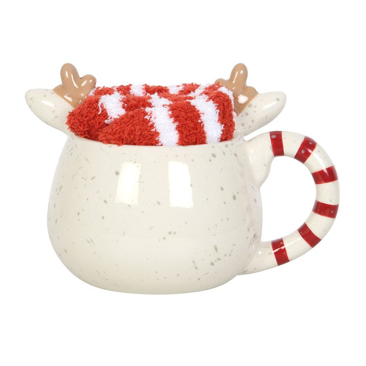 Ceramic mug with reindeer design and candy cane handle on a white background