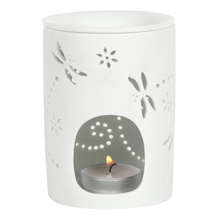 White ceramic oil burner with floral dragonfly cutouts on a white background for oil fragrance