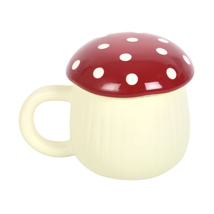 Mushroom-shaped mug with a red cap and white spots on a white background