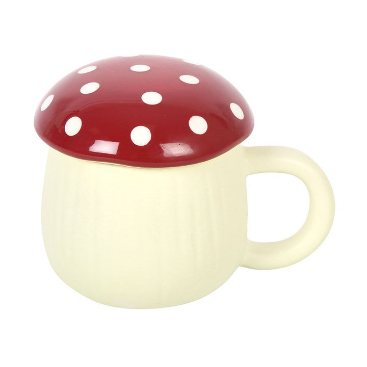 Mushroom-shaped toadstool mug with red cap and white polka dots on a white background