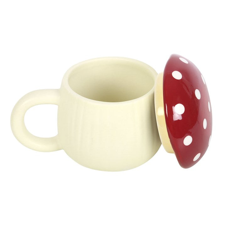 Cream-colored cup with a red mushroom-shaped lid on a white background