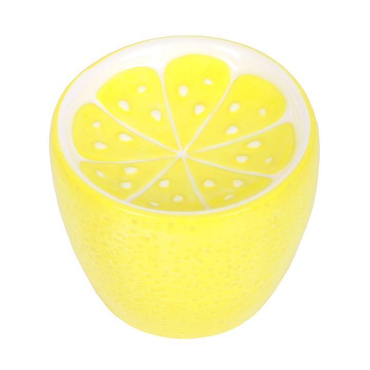 Yellow ceramic oil burner shaped like a lemon on a white background
