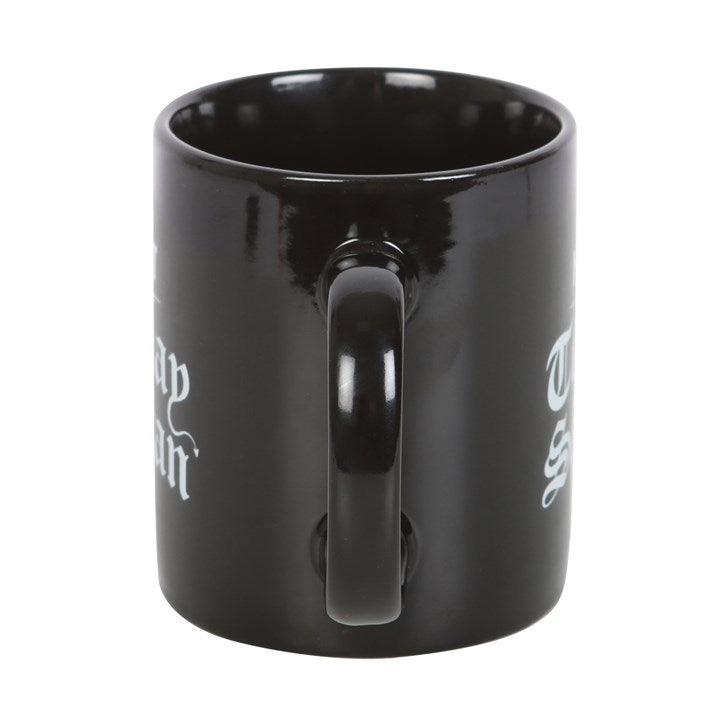 Black mug with white text on a white background