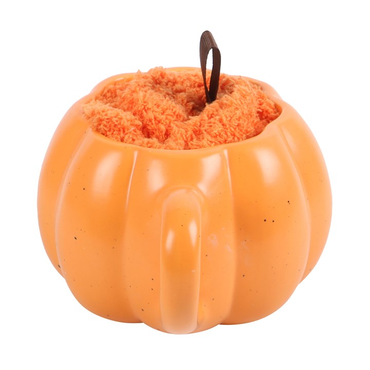 Pumpkin-shaped candle with fluffy interior on a white background