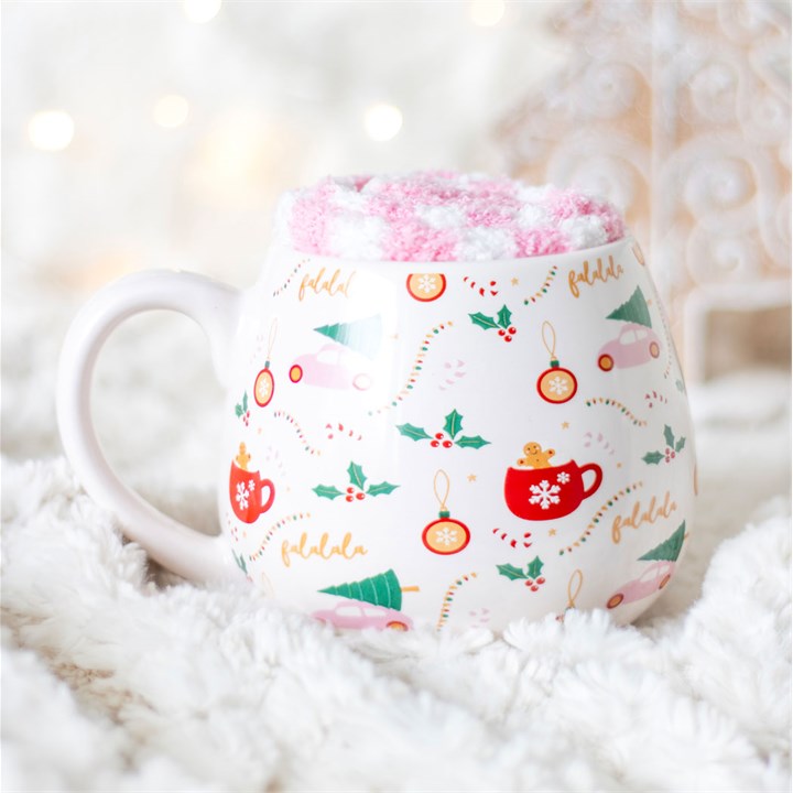 Decorative mug with festive design on a fluffy white surface