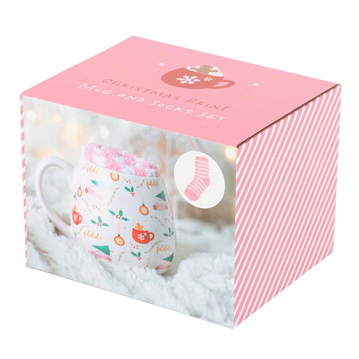 Pink box containing a mug and socks set with Christmas print on a white background