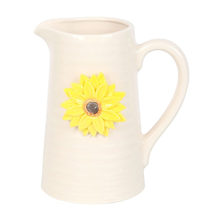 White ceramic jug with a yellow sunflower decoration on a white background