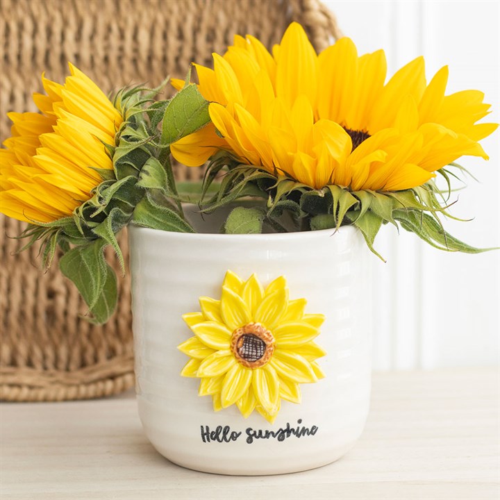 White vase with sunflower design and text 'Hello Sunshine' on a light background