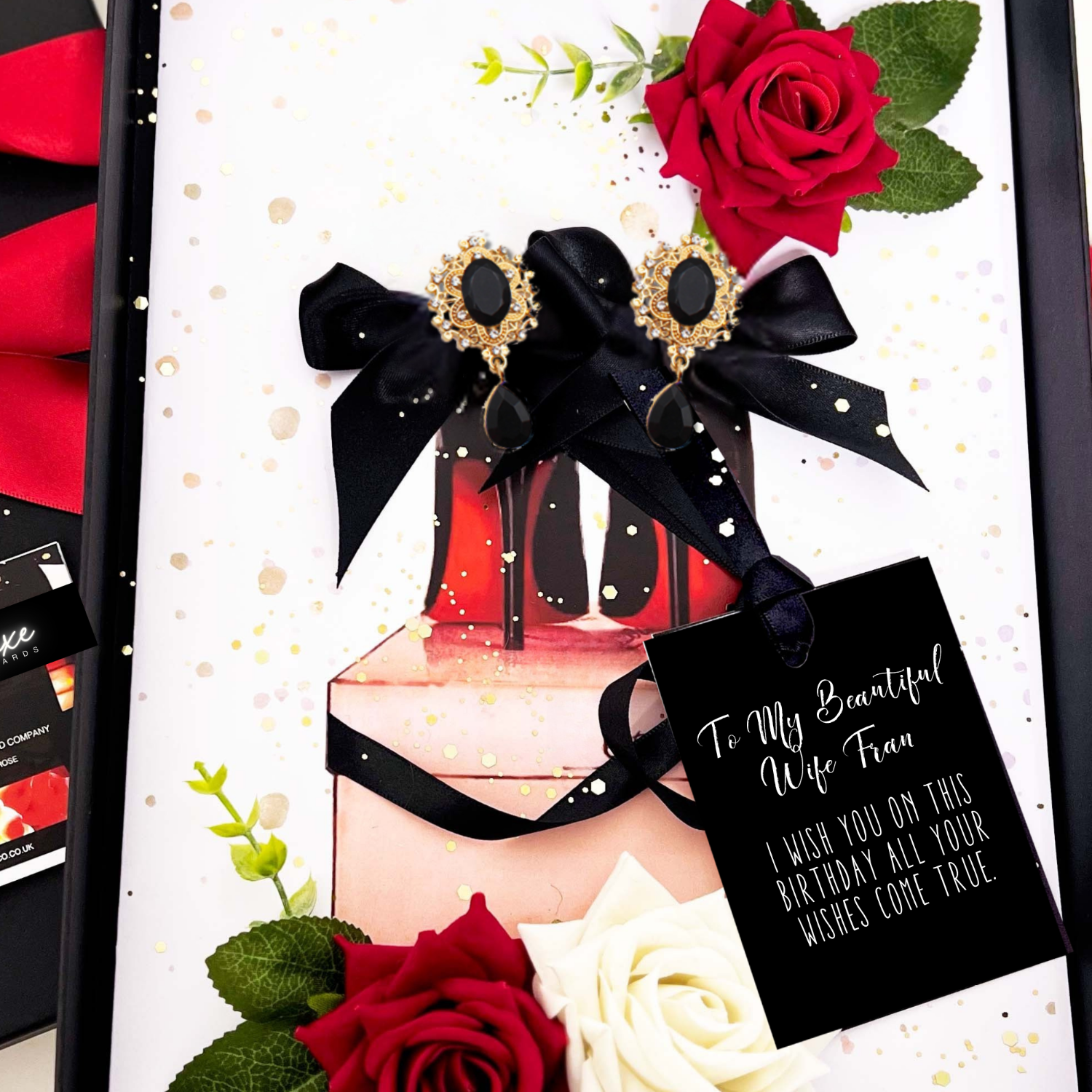 Wife luxury red lipstick and heels birthday card, earrings, and flowers on a white background