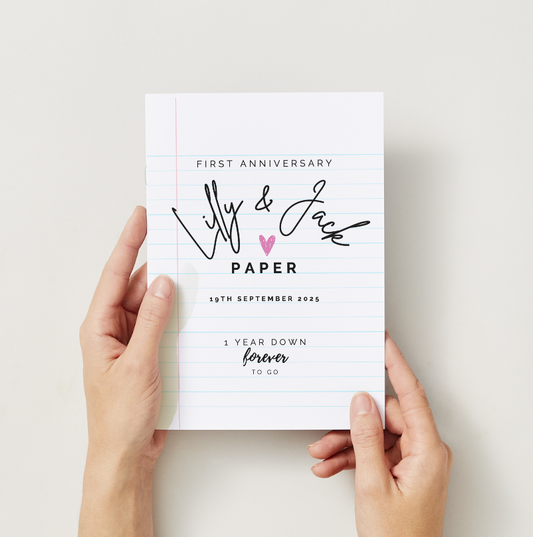 Personalised Paper Anniversary Gift White notebook with personalized text held by hands on a light background