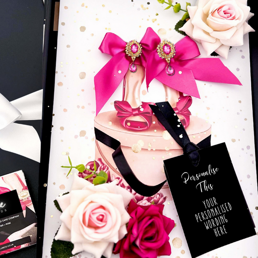 Luxury Personalised Pink high-heeled shoe Card handmade with decorative bows, crystals, surrounded by scented handmade everlasting roses and flowers and a black tag for your personalization. Luxury Handmade Personalised Cards for Special Occasions by Luxe Cards