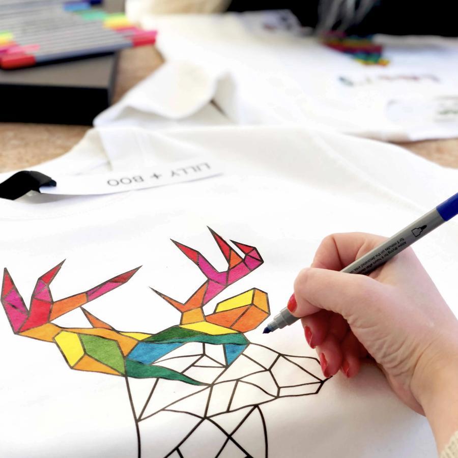 Colourful reindeer christmas jumper in white with rainbow reindeer
