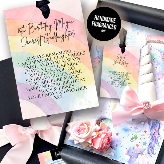 Luxury Handmade Personalised Goddaughter 16th Unicorn birthday card. A personalized unicorn-themed birthday card set, featuring a rainbow card reading '16th Birthday Magic Dearest Goddaughter' with a pastel rainbow watercolor background, with a pink ribbon, and decorative flowers and black gift box
