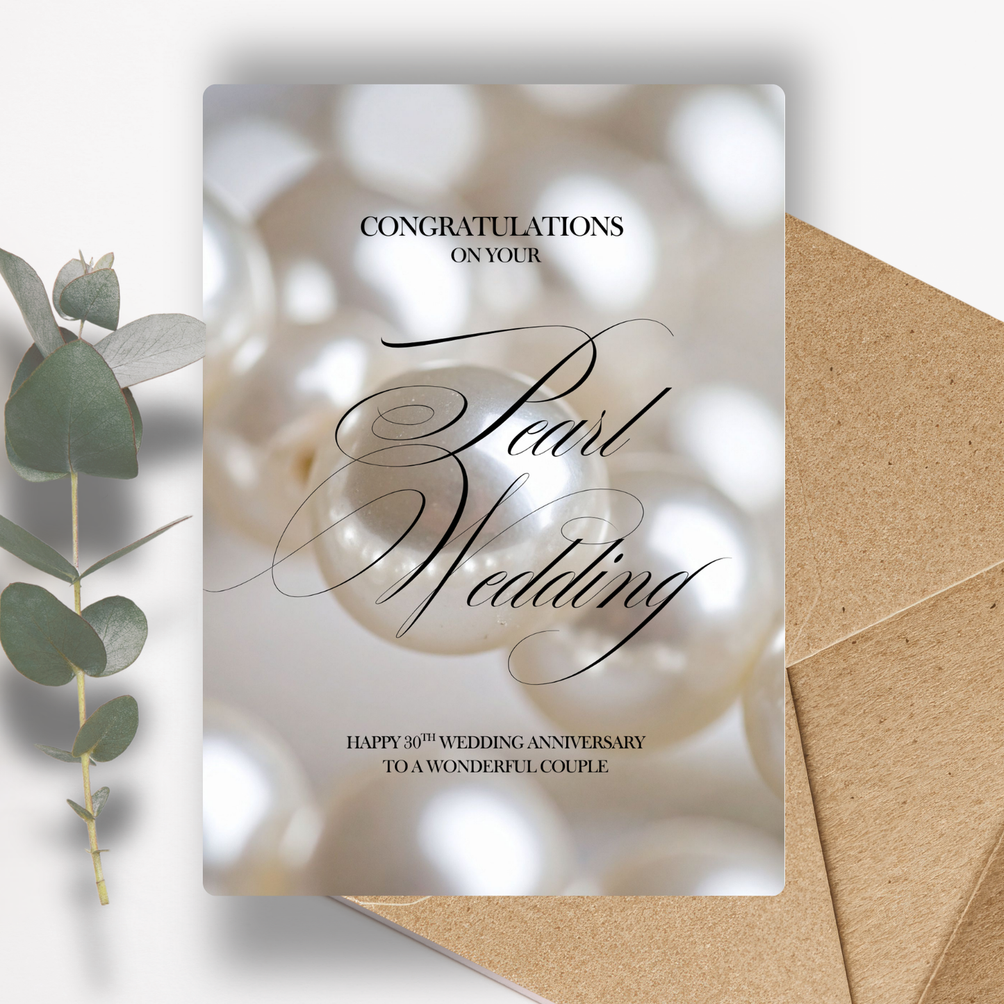 Congratulations on your Pearl Wedding Happy 30th Wedding Anniversary To a Wonderful Couple Pearl wedding anniversary card with a pearl and eucalyptus leaf on a white background