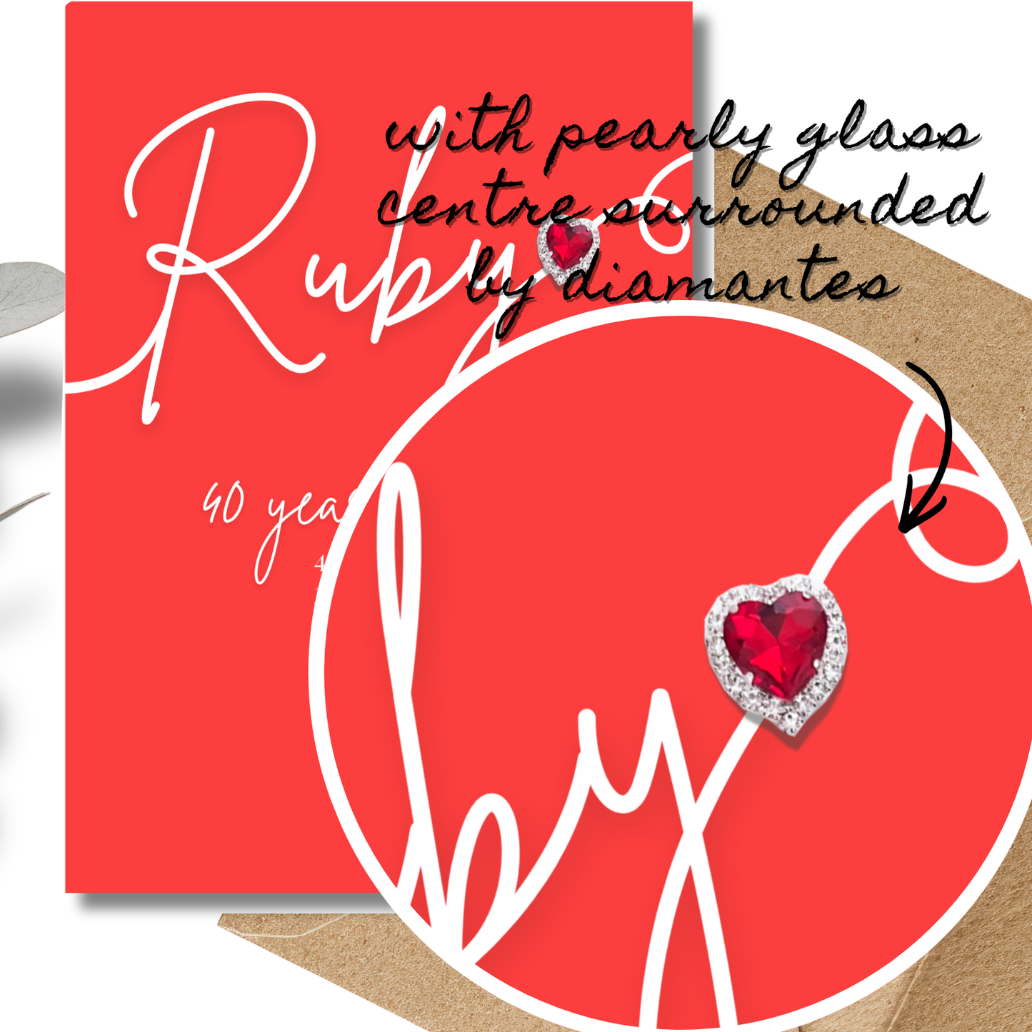 Heart-shaped ruby gemstone surrounded by diamonds on a red card with text on the Handmade A5 Swirly Sparkly Diamante Ruby Heart Anniversary Card