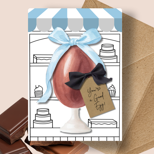 Blue Personalised Chocolate Scented Handmade A5 Easter Greetings Card - Greeting card with chocolate egg and decorative bow, featuring a tag with text, on a striped background.