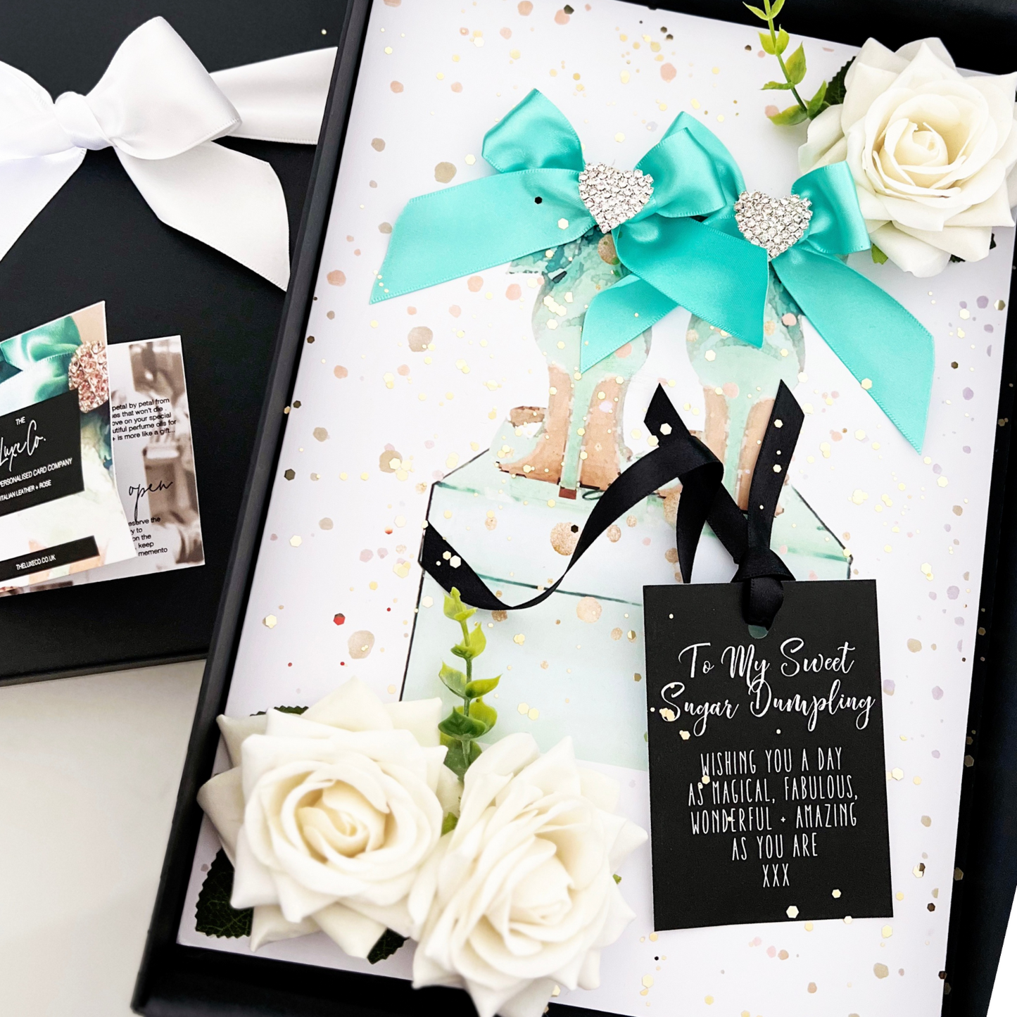 Luxury Gift boxed 40th birthday card handmade with blue ribbons, white everlasting roses, crystals, glitzy hearts, turquoise bows, and a personalized tag for a unique card for her