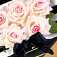 Luxury Birthday Bouquet gift handmade into a card of pink and white roses with a black bow on a white background