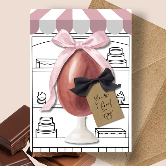 Pink Good Egg Chocolate Enveloped Easter Cards A5 - Greeting card with chocolate egg and decorative bow on a cake shop background