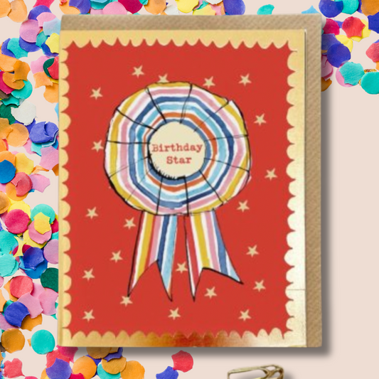Birthday card with colorful star design on a red background surrounded by confetti.