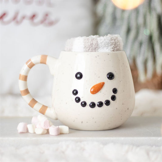 Snowman-themed mug with decorative elements on a light background