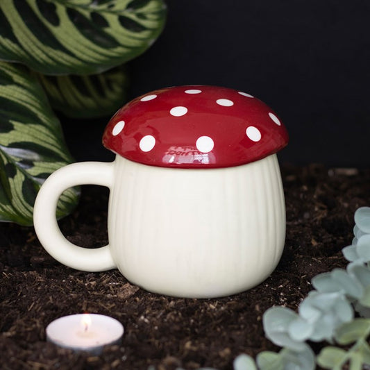 Mushroom-shaped mug with a red cap and white spots on a dark background