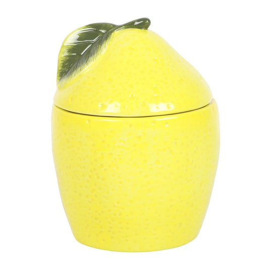 Yellow lemon-shaped oil burner wax warmer container with a lid on a white background