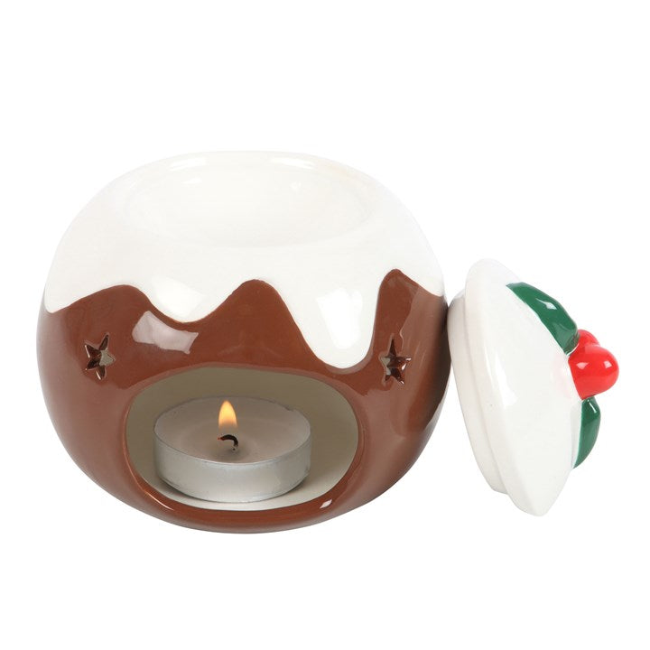 Ceramic Christmas pudding with a lit tealight candle inside on a white background