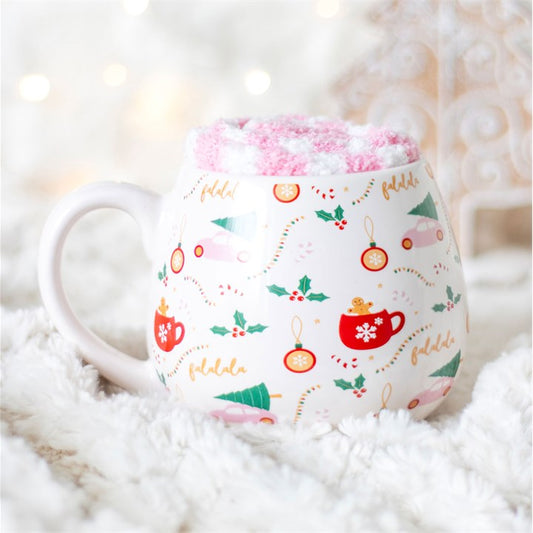 Decorative mug with festive design on a fluffy white surface
