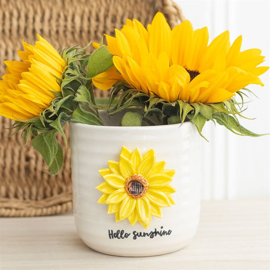 White vase with sunflower design and text 'Hello Sunshine' on a light background
