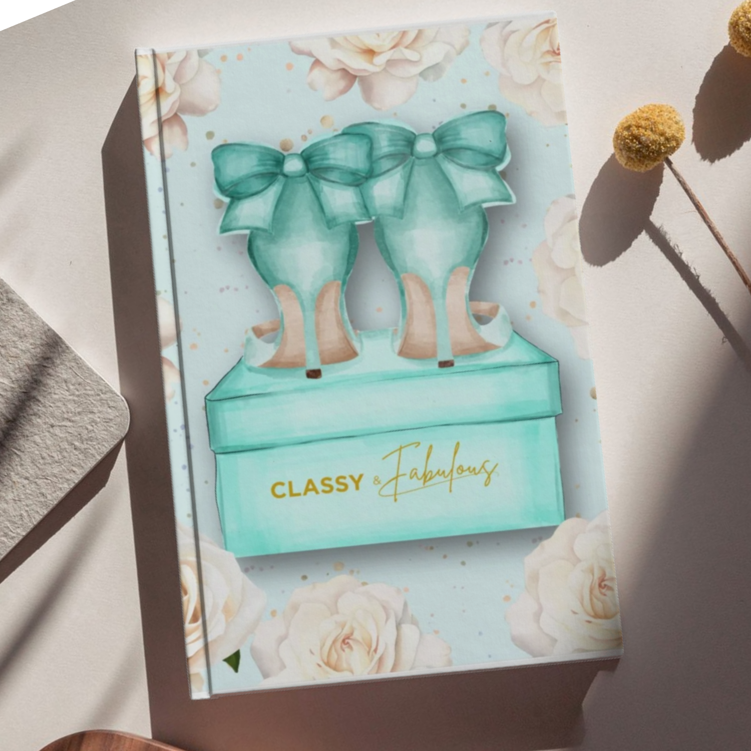 Product packaging with teal bows and 'Classy & Fabulous' text on a floral background