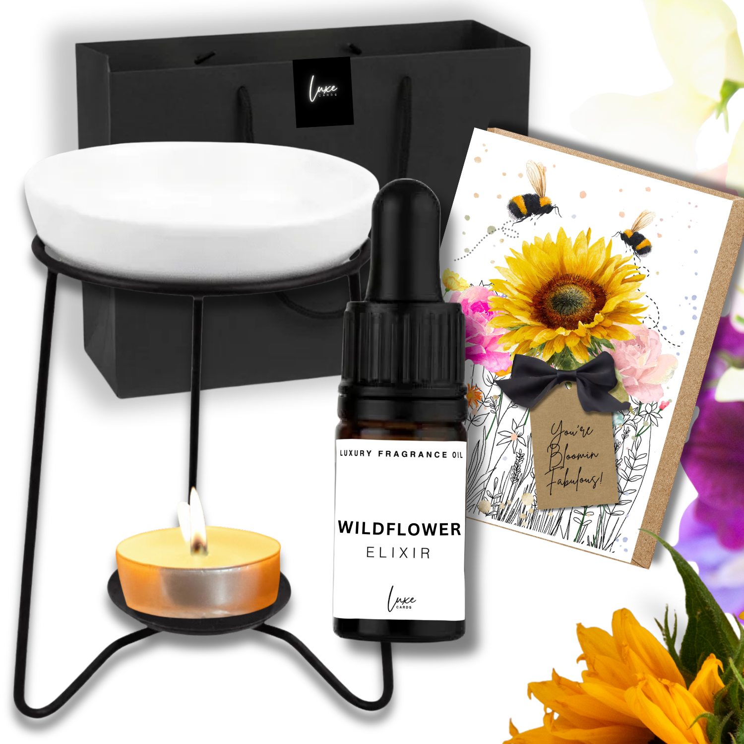 Luxury Home Fragrance Gift in Wildflower elixir bottle, candle, and sunflower-themed card on a white background