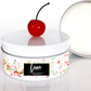 Luxury Birthday Cake Scented Candle tin with a cherry on top and 'Luxe Candles' 