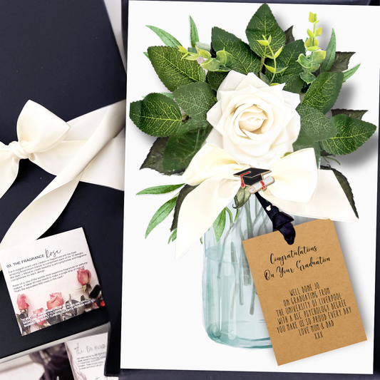 Luxury personalised graduation card with Floral arrangement with a decorative tag and gift box on a white background