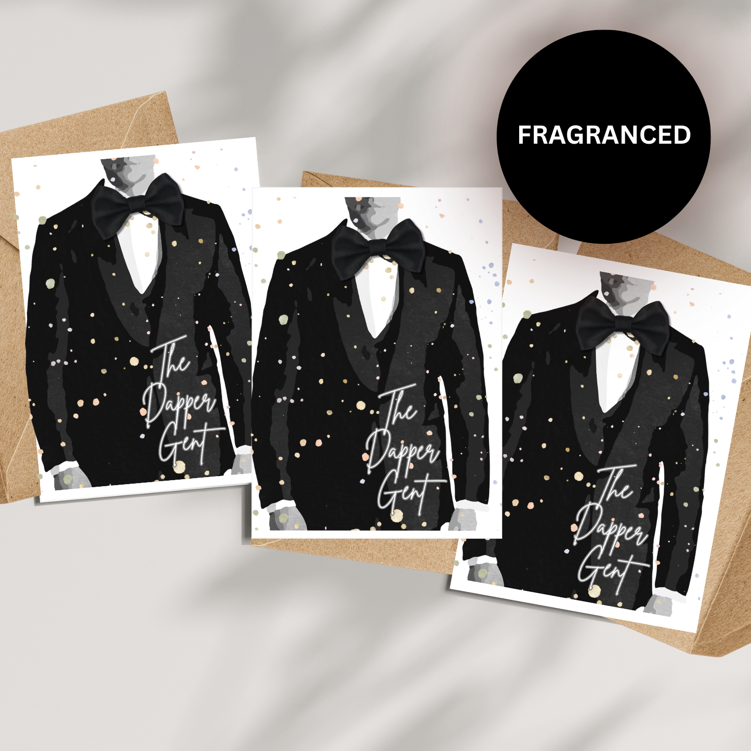 Set of 3 Tux Cards for Him (A5 Card with envelope) - Three handmade cards featuring illustrations of a black tuxedo with 'The Dapper Gent' text on a textured surface handcrafted with satin dickie bow and fragranced in cologne