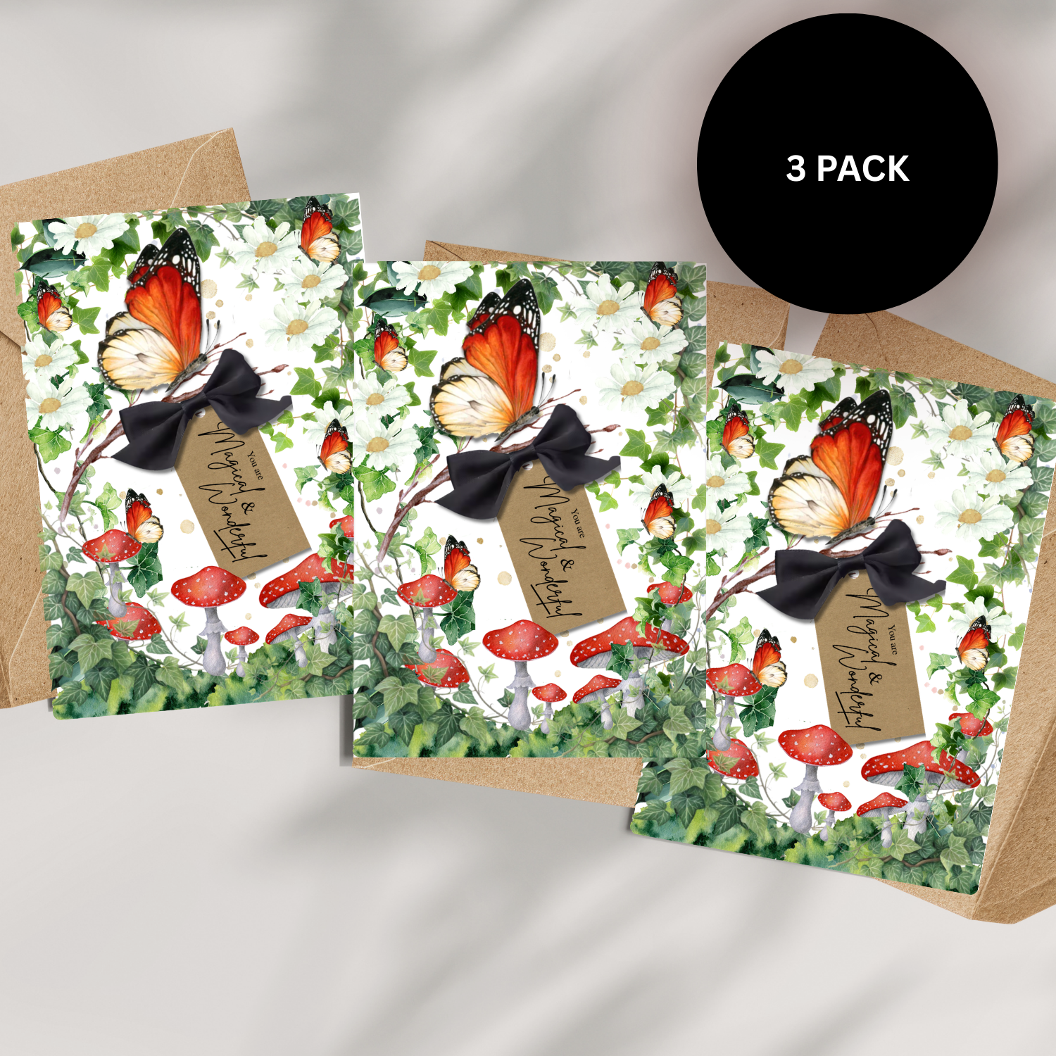 Pack of Three greeting cards with orange monarch butterfly and mushroom toadstool design in green woodland scene for birthday reads 'you are magical and wonderful!'