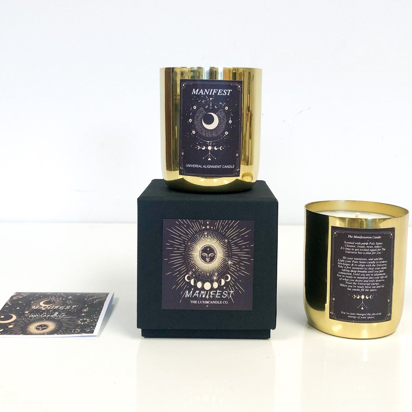Palo santo fragranced candles for manifesting your dreams. Gold candle in black box makes luxury gift