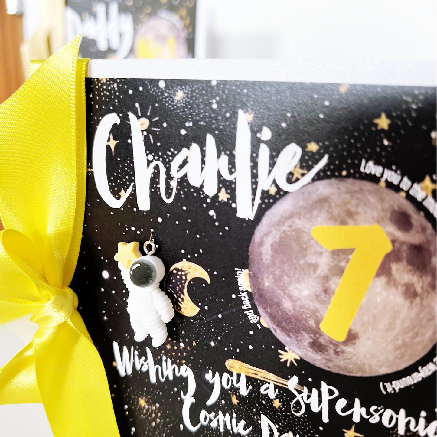 Close up of astronaut charm on space themed boys cards personalised | The Luxe Co